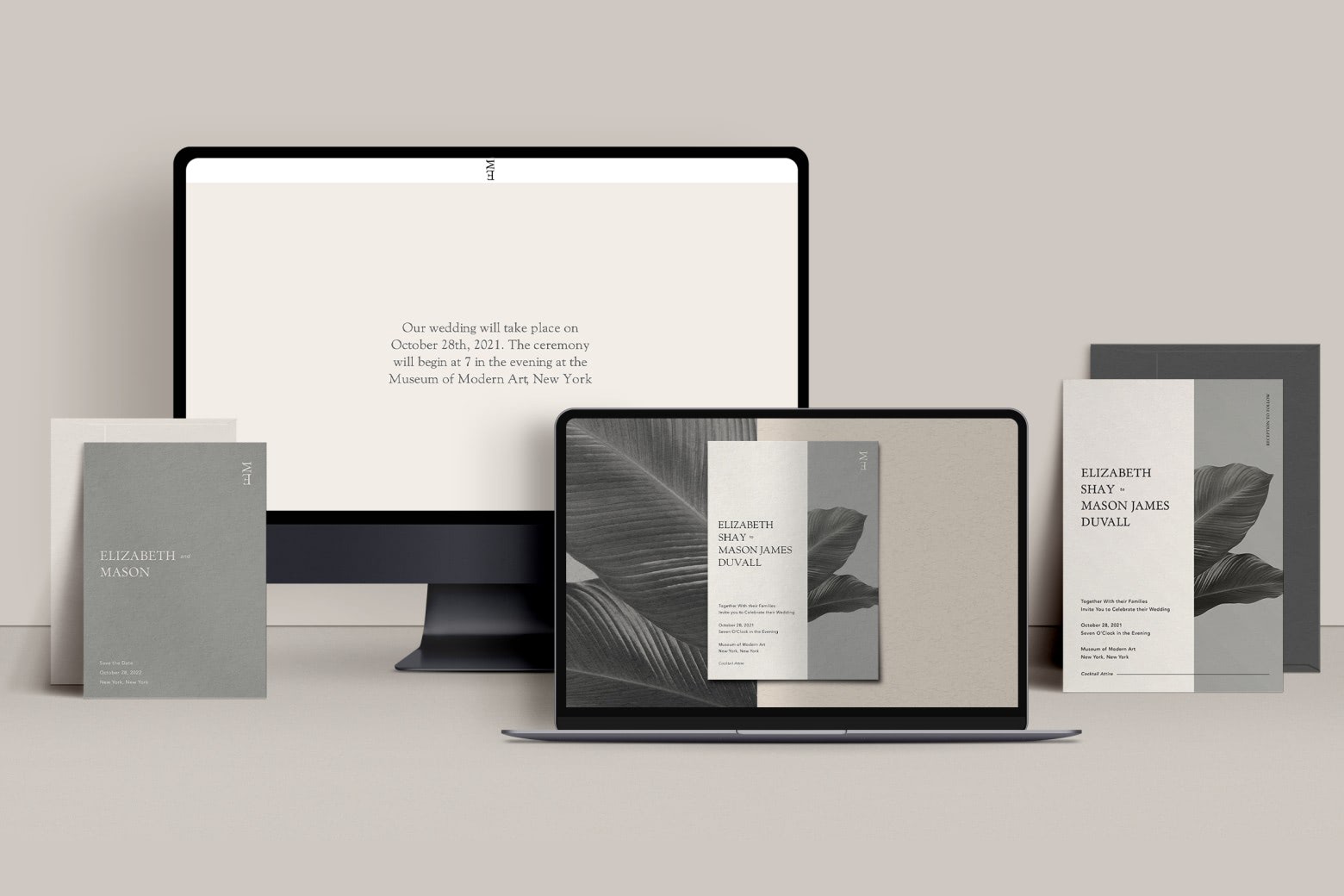 A monitor, laptop screen and printed stationery, all with a gray and white color scheme and leaf accents